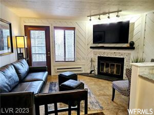 Living room with a baseboard radiator and rail lighting