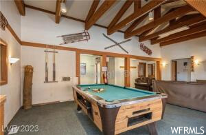 Recreation room with billiards, dark carpet, beam ceiling, and high vaulted ceiling