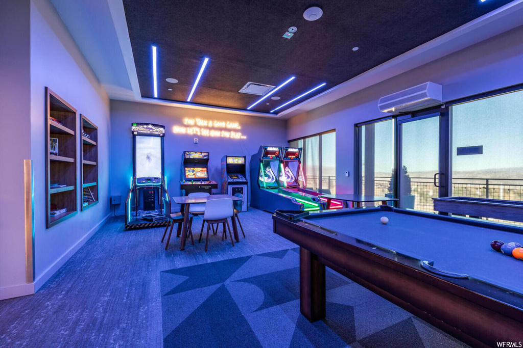 Recreation room with dark colored carpet and pool table