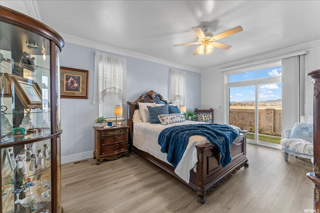 Bedroom with access to exterior, ceiling fan, ornamental molding, and light hardwood / wood-style floors