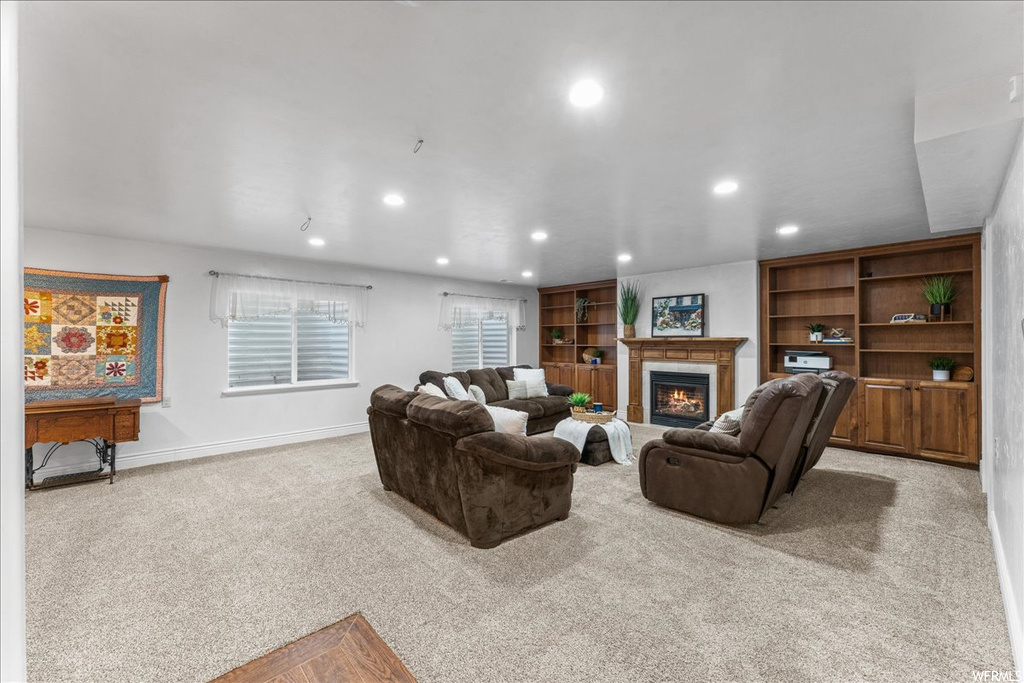 Living room with light colored carpet and built in shelves