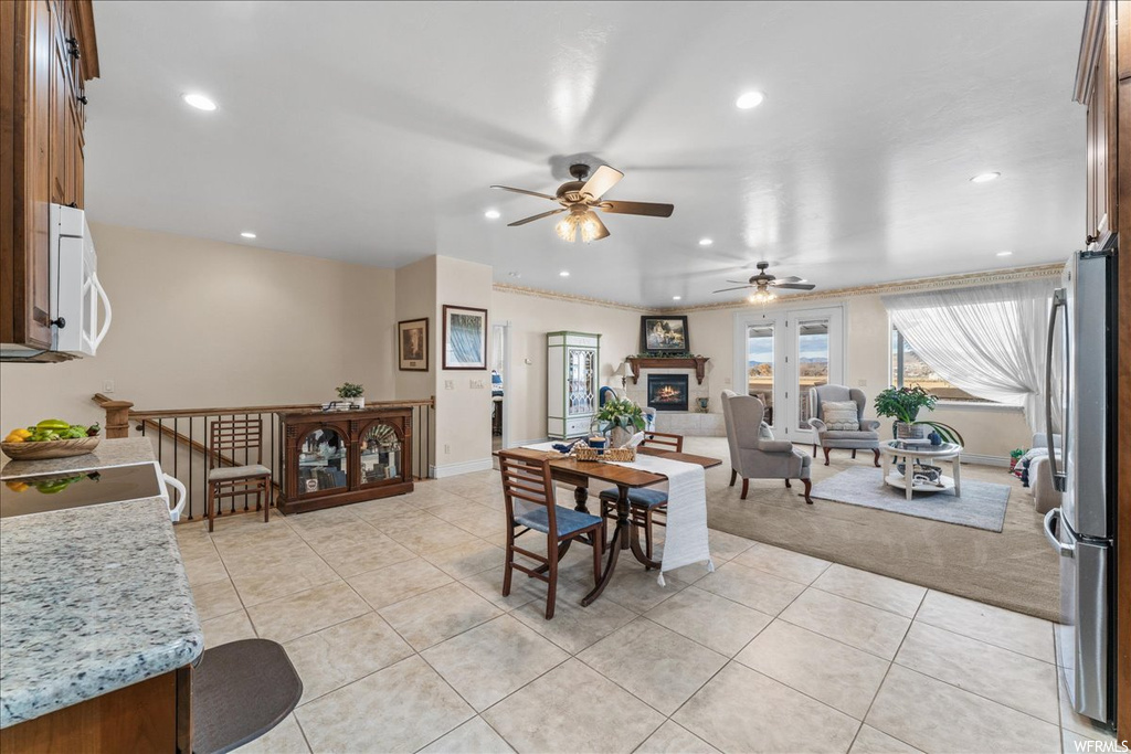 Dining space with light tile flooring and ceiling fan
