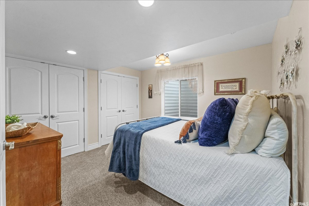 Bedroom featuring two closets and light carpet