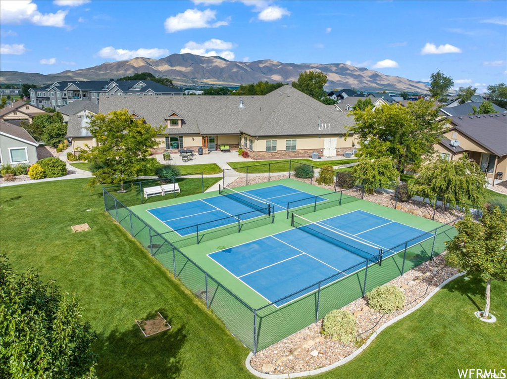 View of sport court with a lawn and a mountain view