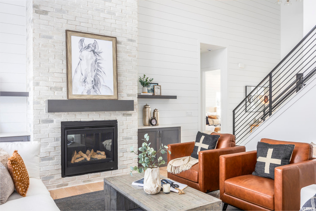 Living room with dark hardwood / wood-style floors and a brick fireplace