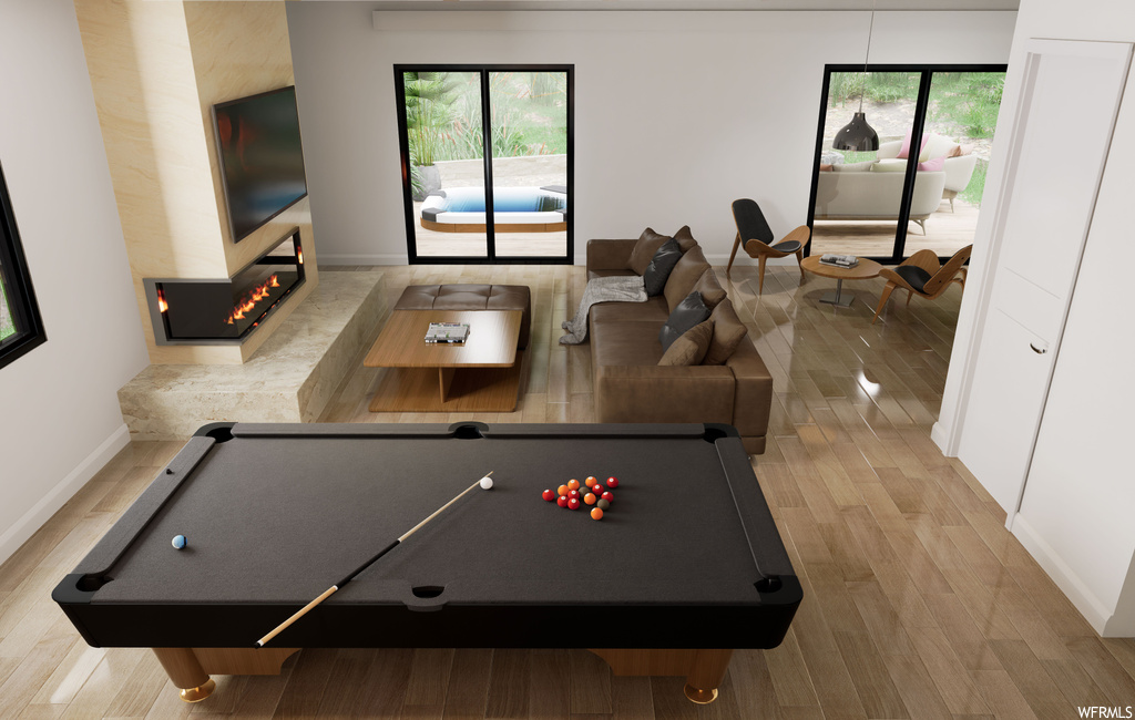 Game room with billiards and light hardwood / wood-style floors
