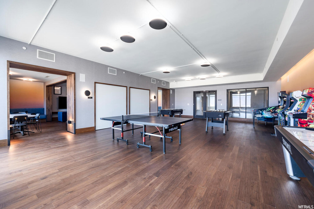 Rec room with dark hardwood / wood-style floors