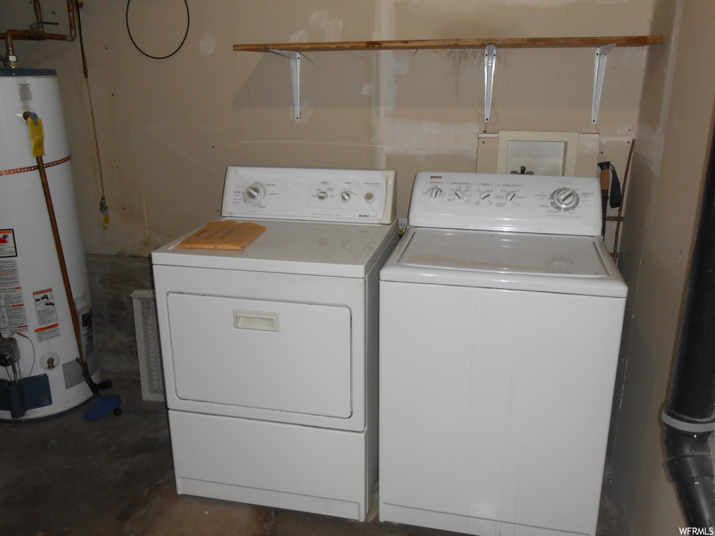 Laundry room with washer and clothes dryer, water heater, and hookup for a washing machine
