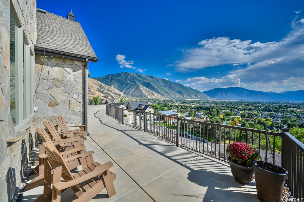 View of terrace with a balcony and a mountain view