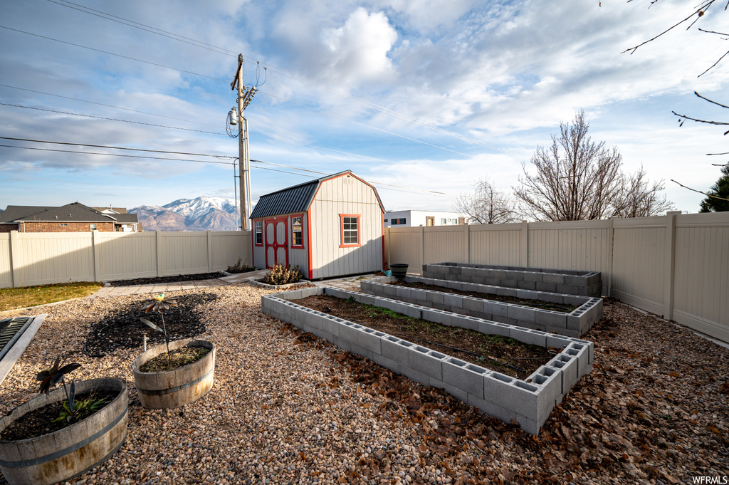 View of yard with a storage shed and a mountain view