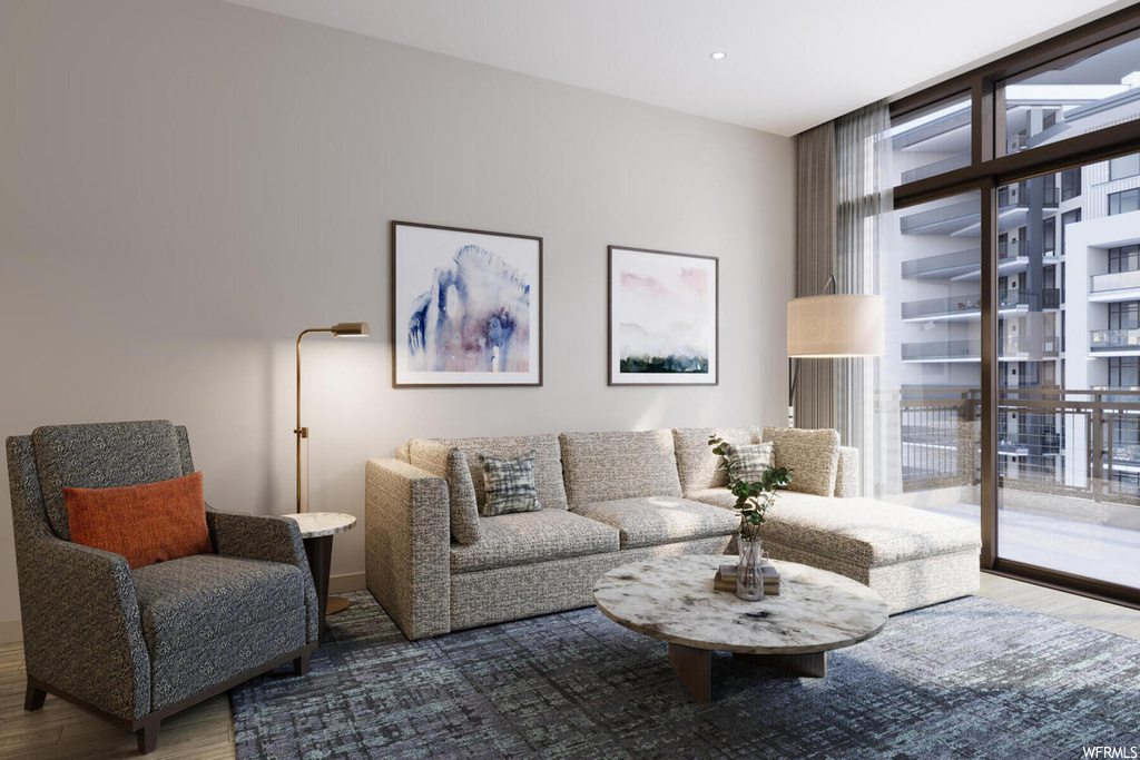 Living room featuring dark hardwood / wood-style floors, a wealth of natural light, and a wall of windows