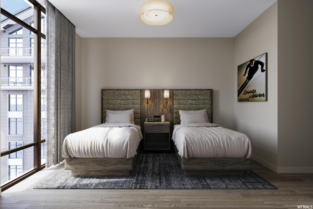 Bedroom featuring dark hardwood / wood-style floors, multiple windows, and expansive windows