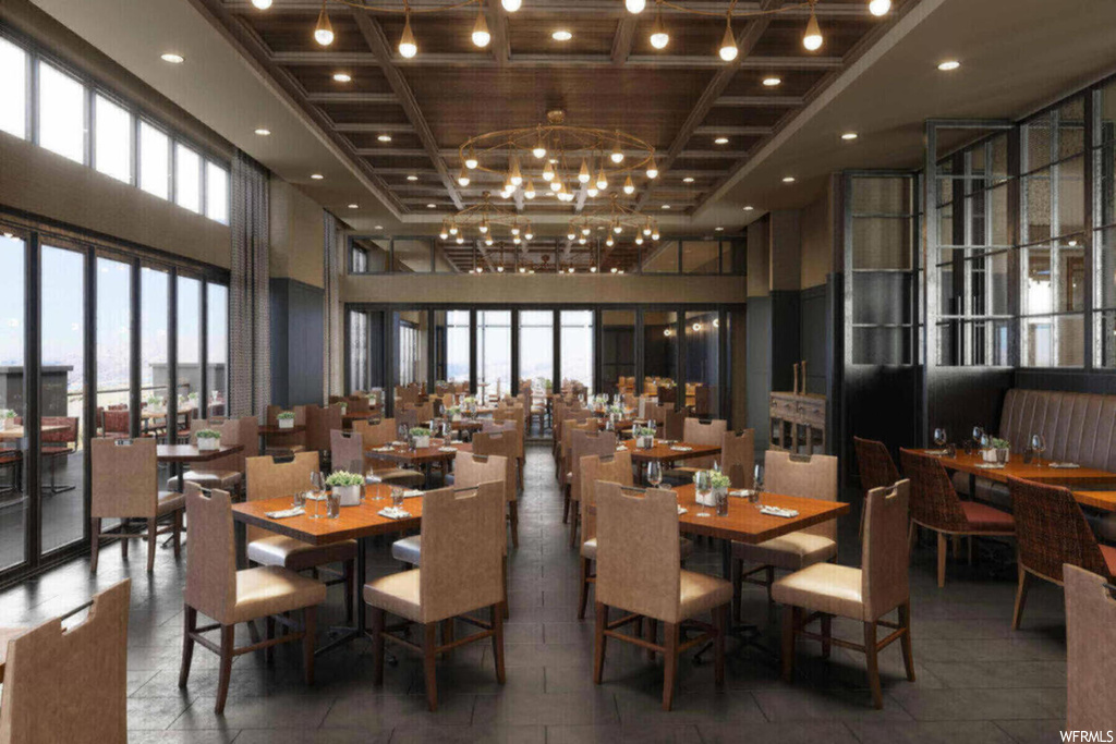 Dining space with a notable chandelier, a high ceiling, and tile flooring