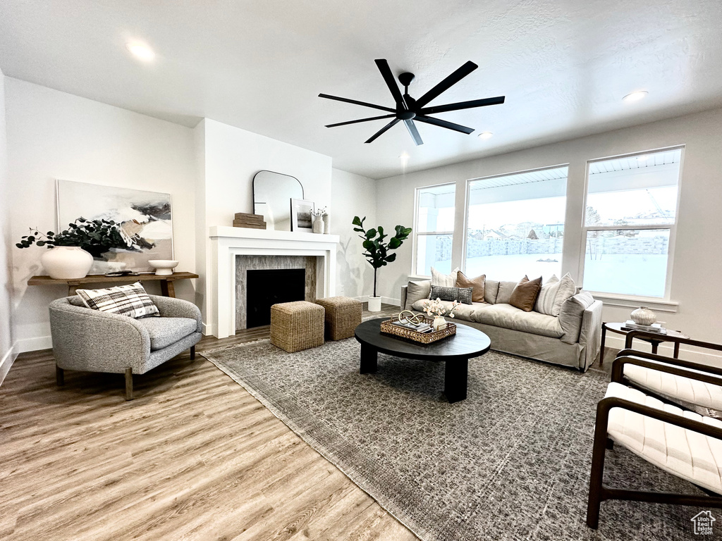 Living room featuring plenty of natural light, light wood-type flooring, and ceiling fan