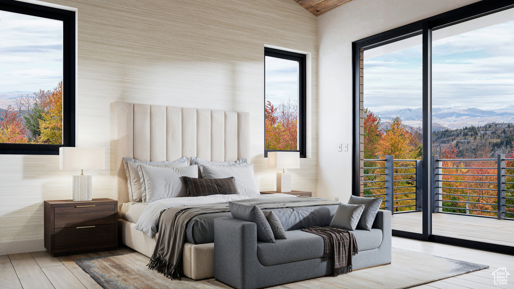 Bedroom with access to exterior, a mountain view, and light hardwood / wood-style flooring