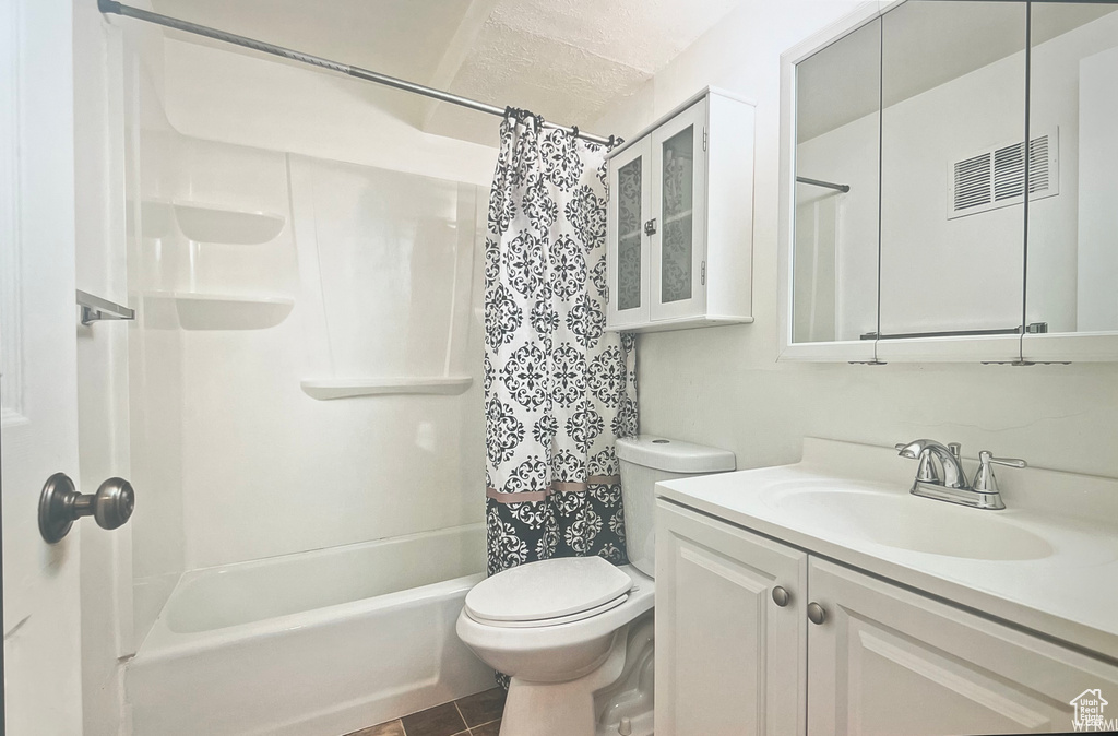 Full bathroom featuring large vanity, shower / bath combination with curtain, tile flooring, and toilet