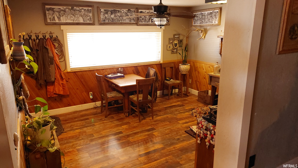 Dining space with dark hardwood / wood-style floors, ceiling fan, and plenty of natural light