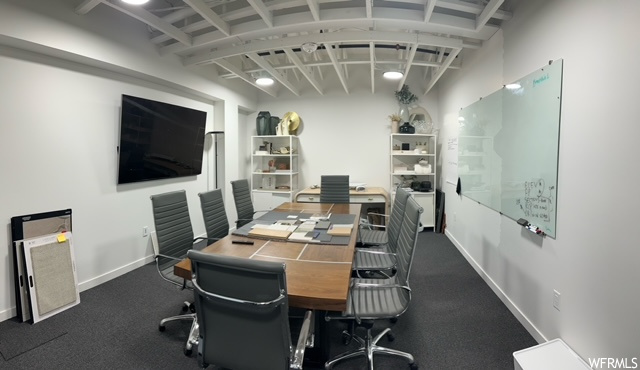 Office area featuring dark carpet