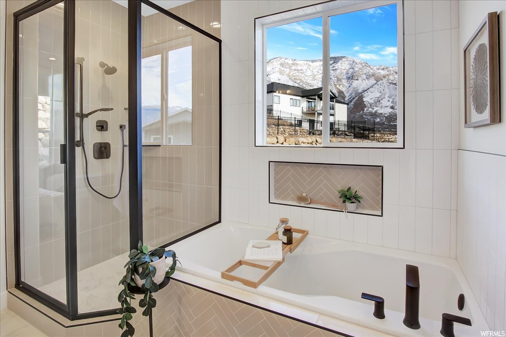 Bathroom featuring plus walk in shower and a mountain view