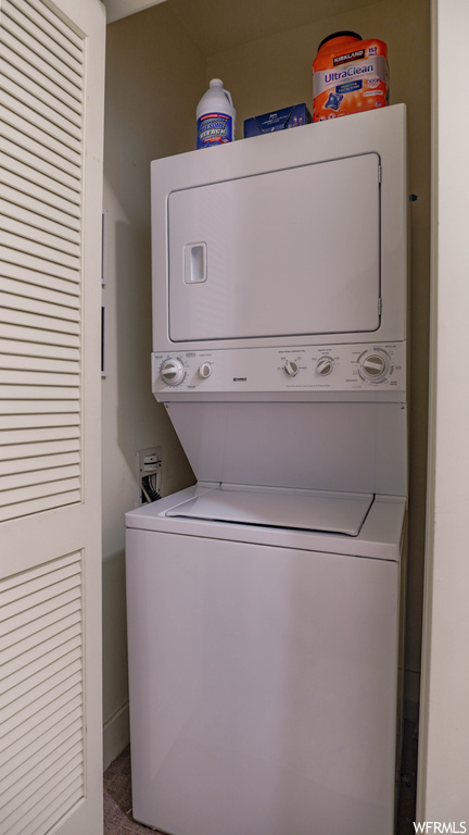 Laundry room featuring stacked washing maching and dryer