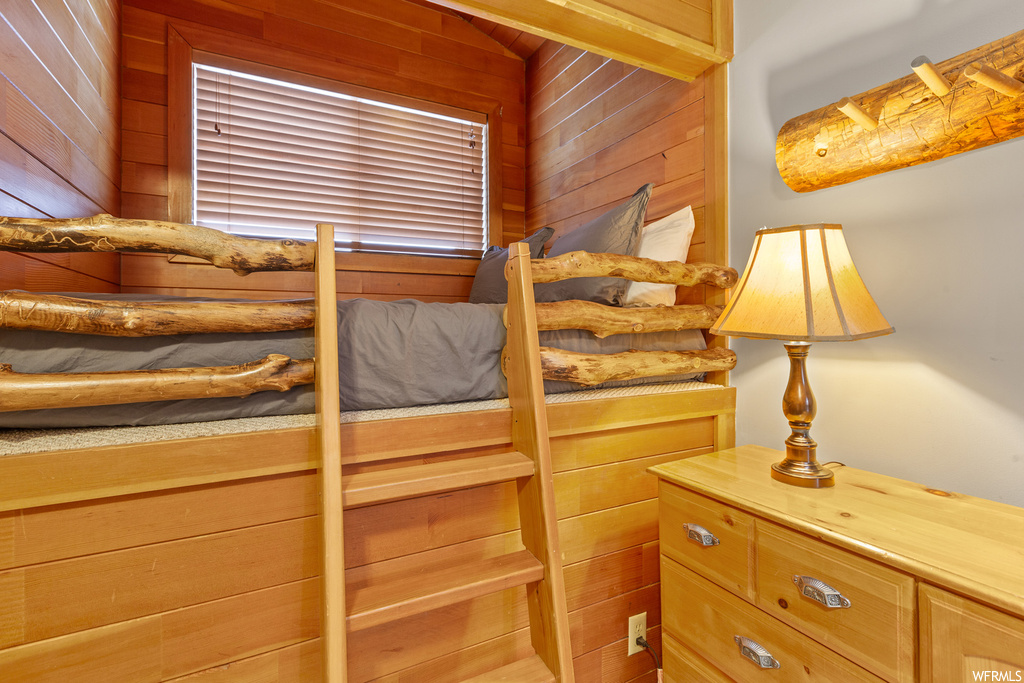 Bedroom featuring wooden walls