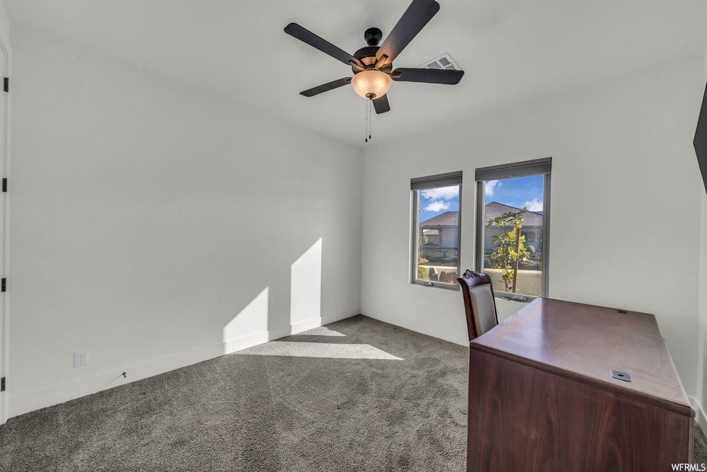 Unfurnished office with light colored carpet and ceiling fan