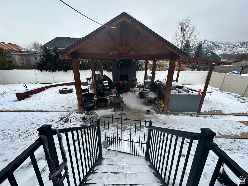 Snow covered patio with a gazebo