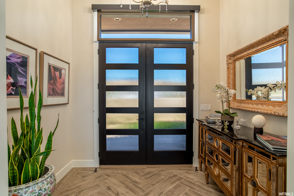 Foyer featuring french doors and light parquet floors
