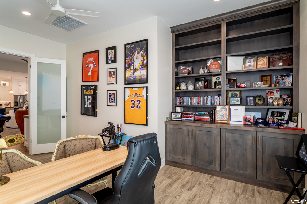 Office area featuring light hardwood / wood-style flooring and ceiling fan