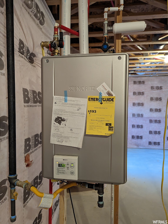 Utility room featuring tankless water heater