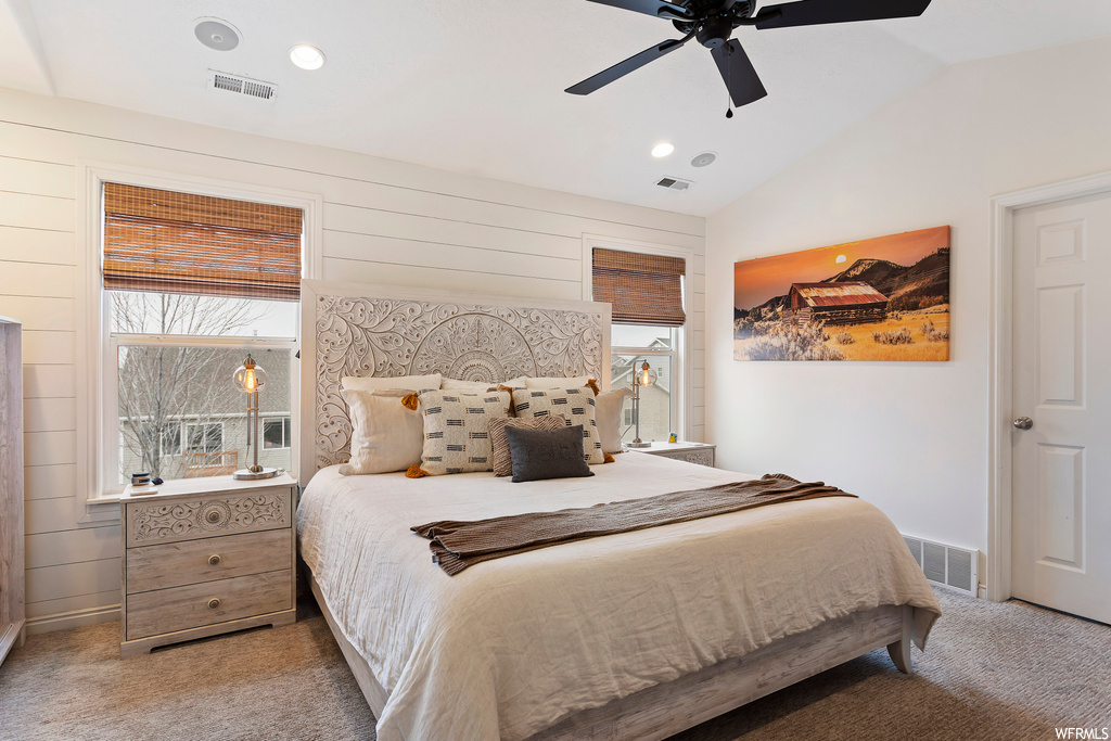 Bedroom featuring lofted ceiling, light colored carpet, and ceiling fan