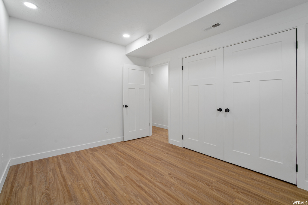 Unfurnished bedroom featuring a closet and light hardwood / wood-style floors