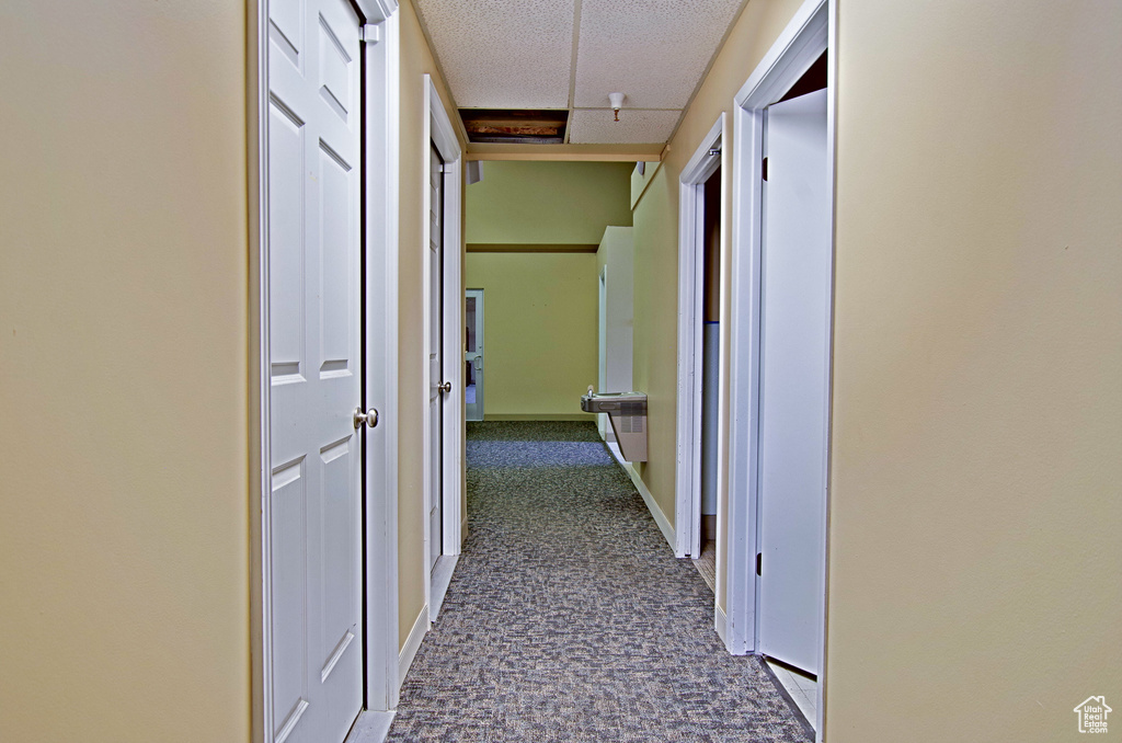 Corridor featuring a textured ceiling