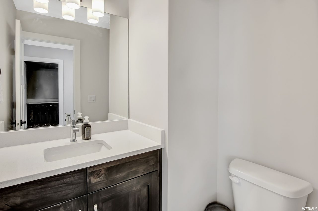Bathroom featuring toilet and large vanity