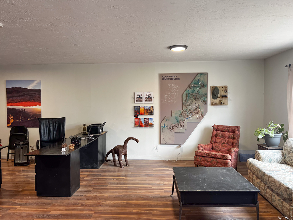 Office area featuring dark hardwood / wood-style floors and a textured ceiling