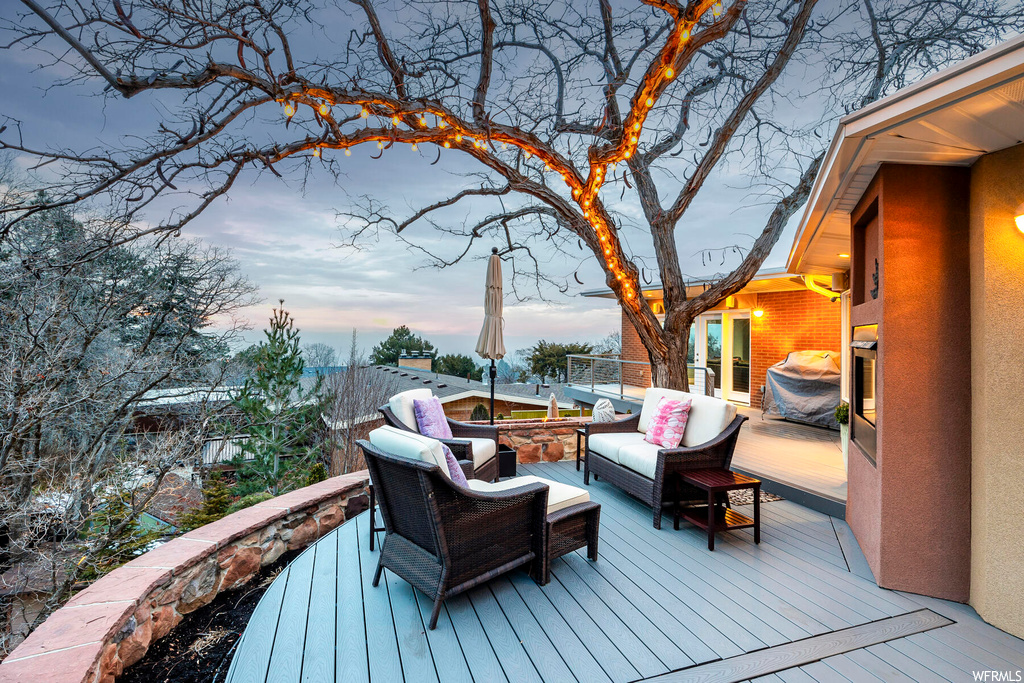 Deck at dusk featuring outdoor lounge area