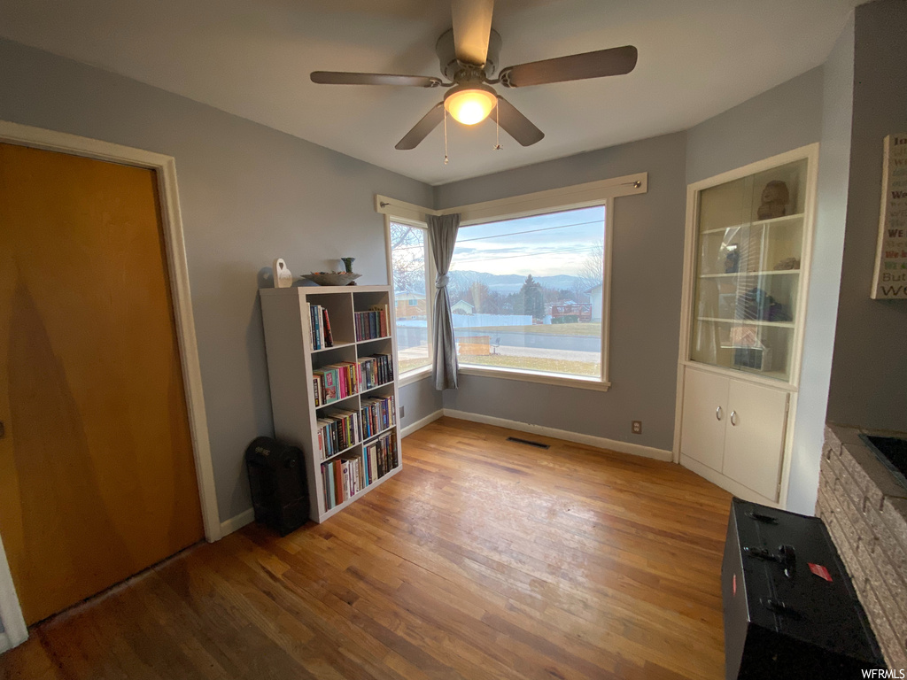 Interior space featuring ceiling fan and light hardwood / wood-style flooring