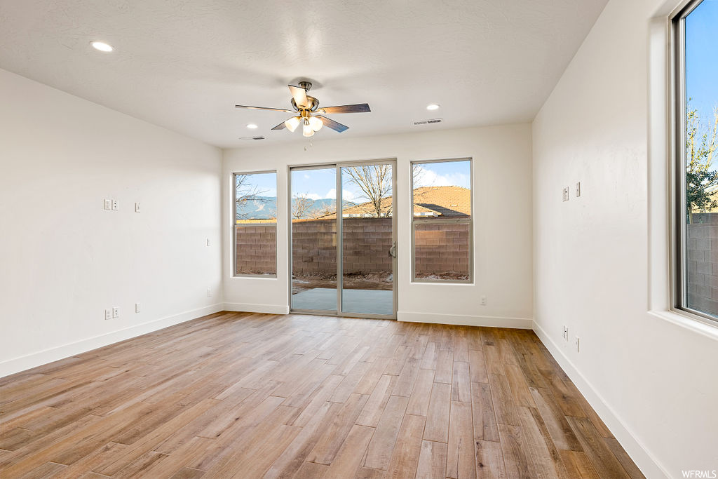 Spare room with ceiling fan and light hardwood / wood-style floors