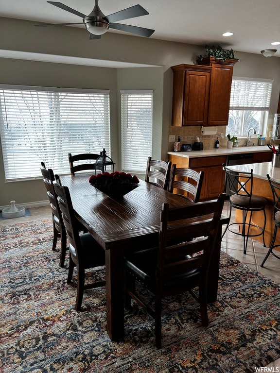Dining area with dark tile flooring and ceiling fan