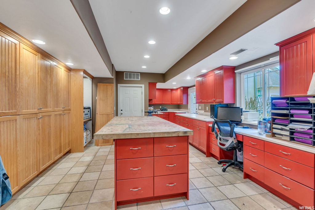 Kitchen with light tile flooring and a center island