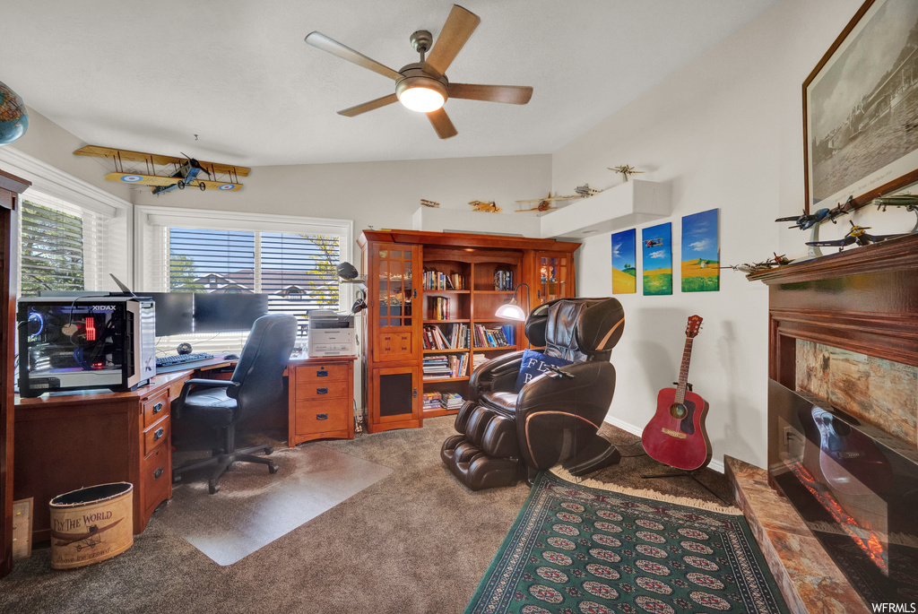 Home office with dark colored carpet and ceiling fan