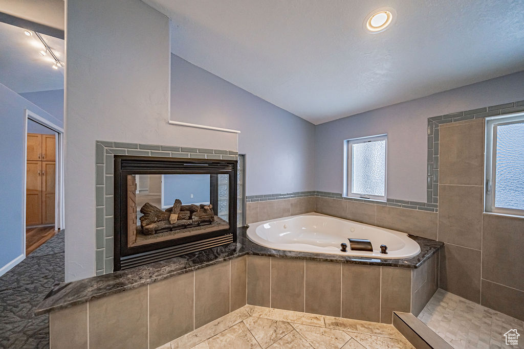 Bathroom with tile floors and a relaxing tiled bath