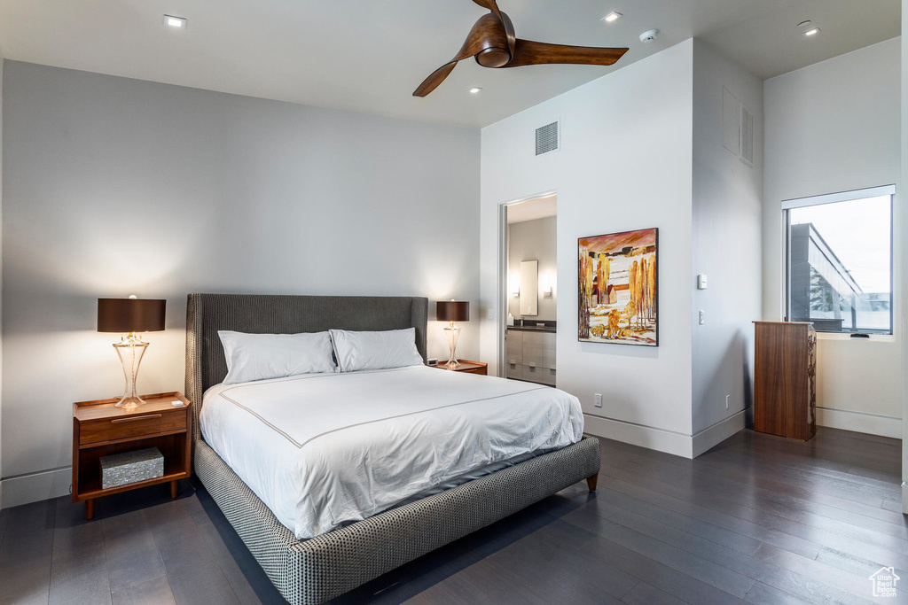 Bedroom featuring wood finished floors, baseboards, ensuite bath, recessed lighting, and a ceiling fan