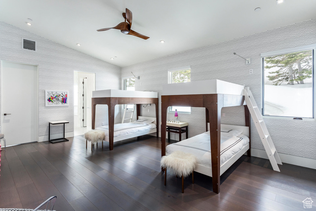 Bedroom with multiple windows, hardwood / wood-style flooring, vaulted ceiling, ceiling fan, and recessed lighting