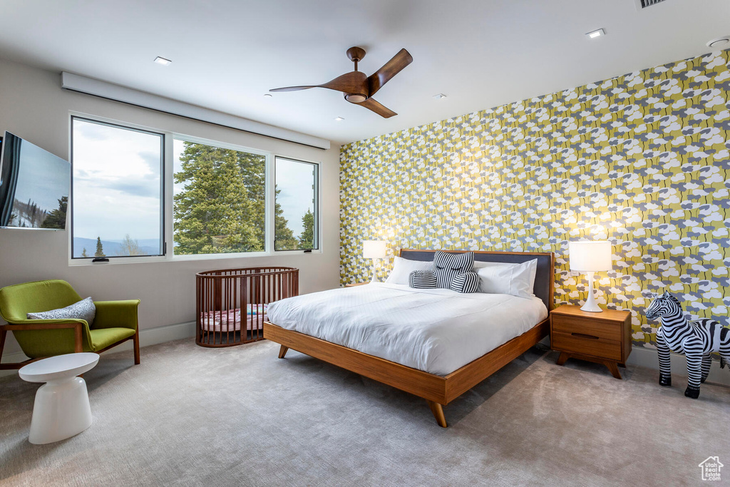 Bedroom featuring ceiling fan and light colored carpet