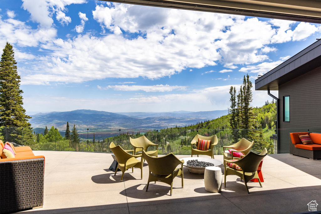 View of patio featuring a mountain view and an outdoor fire pit