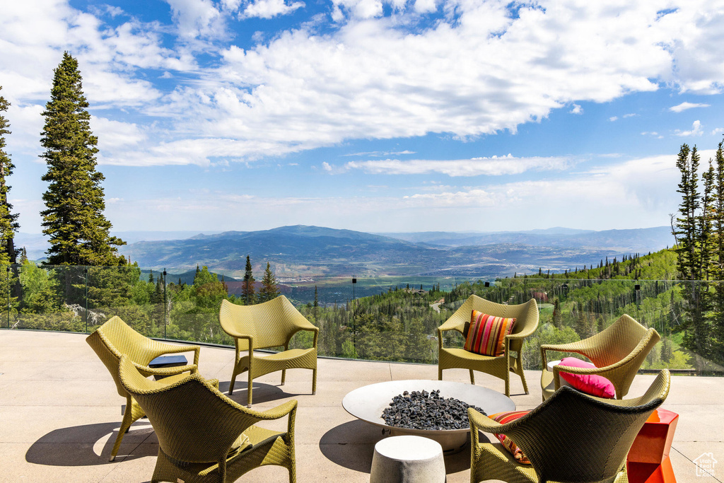 View of patio featuring a fire pit and a mountain view