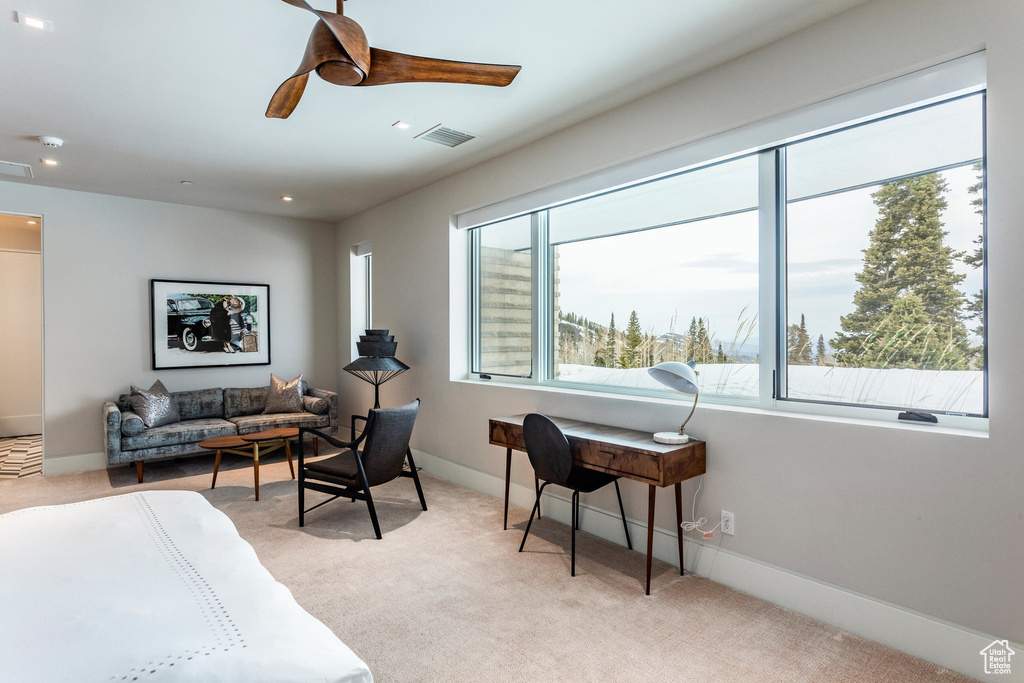 Living area with light colored carpet, ceiling fan, baseboards, and recessed lighting