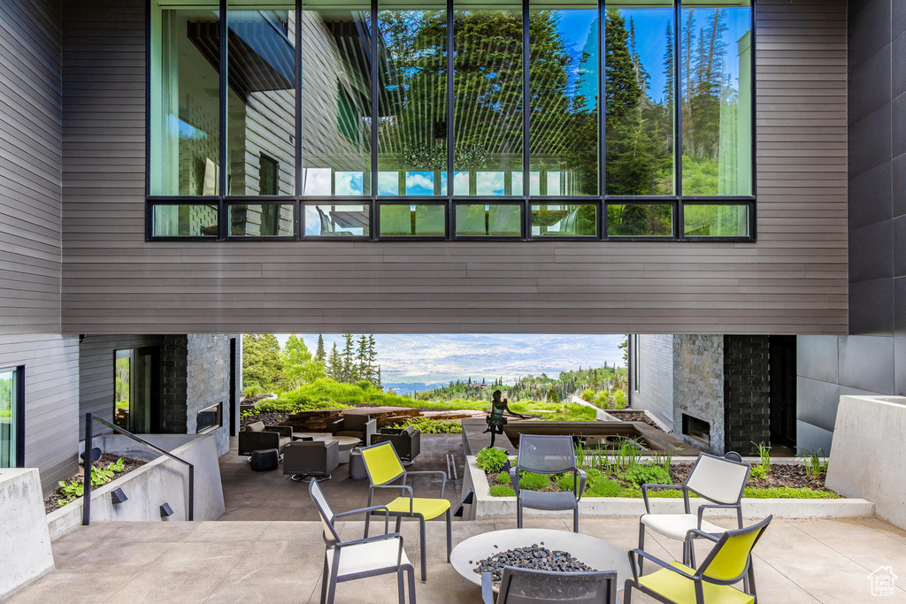 View of patio with an outdoor stone fireplace