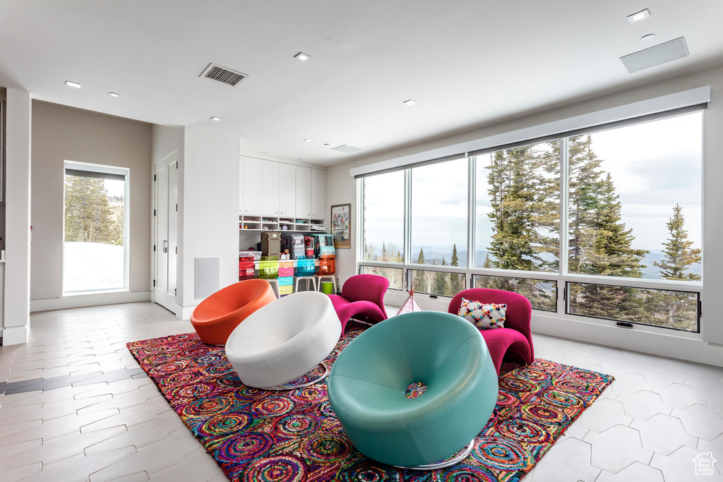 Game room featuring healthy amount of natural light, recessed lighting, and light tile patterned floors